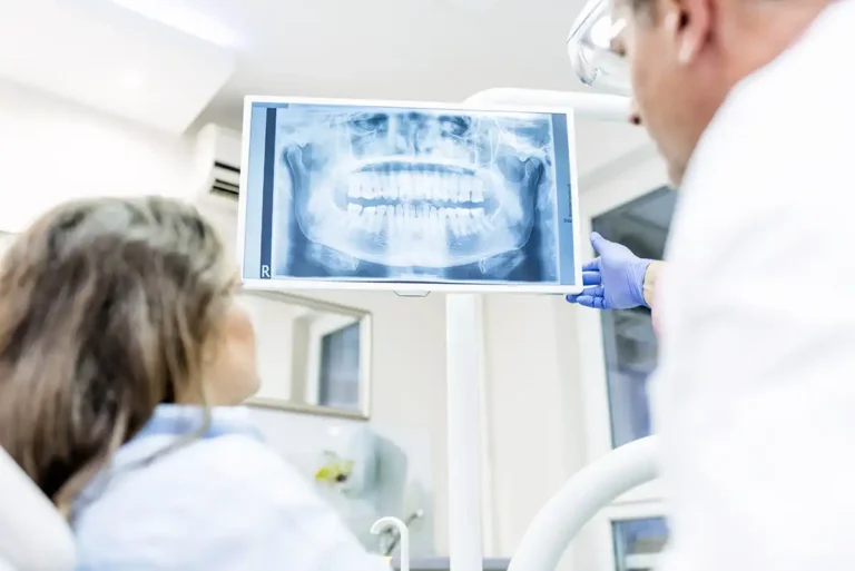 Dental patient and dentist looking at digital x rays